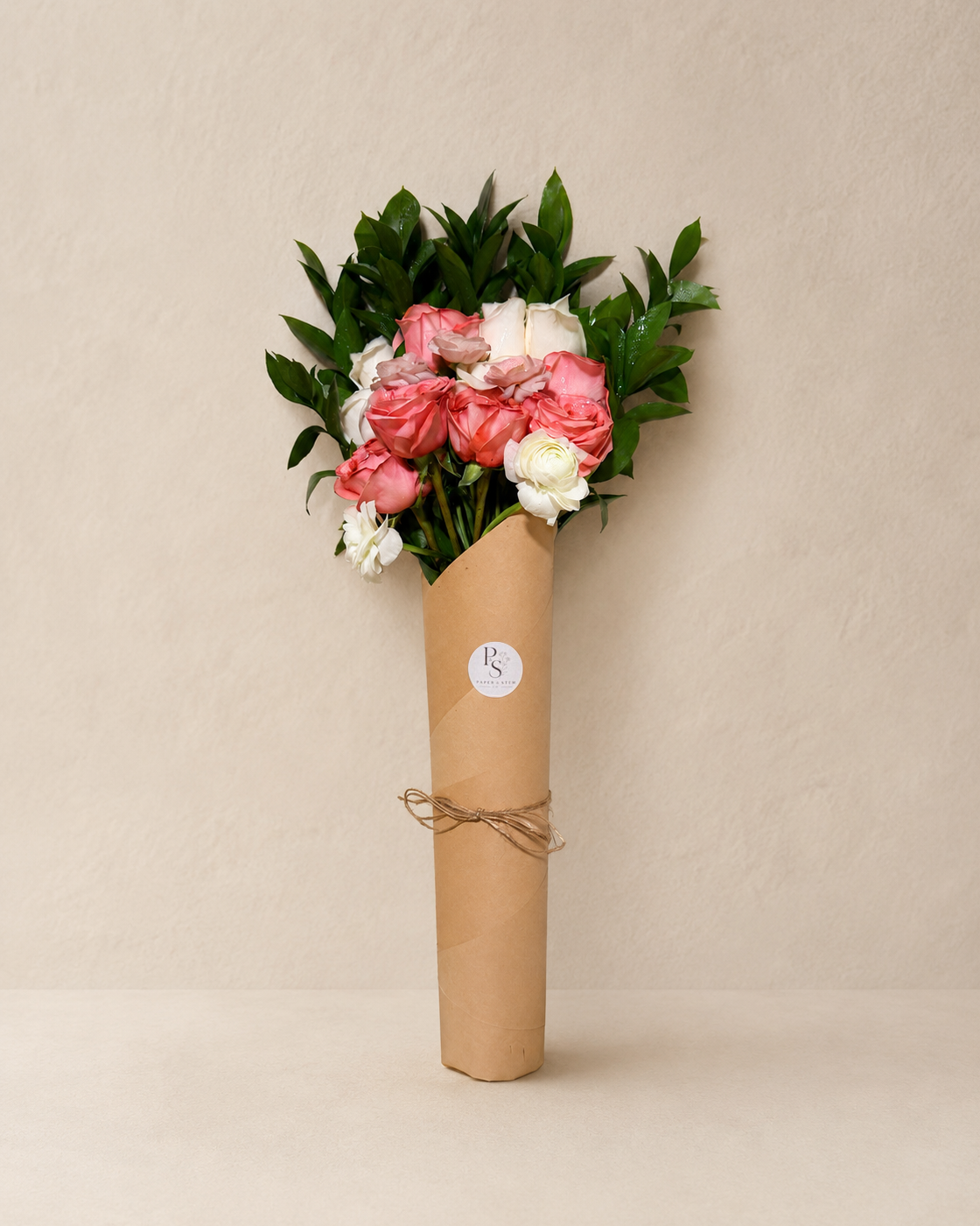 Full blush and ivory bouquet wrapped in Paper & Stem Co. kraft paper